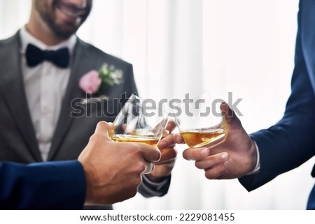 My buddies are welcoming me into the married life. Shot of two unrecognizable groomsmen sharing a toast with the bridegroom on his wedding day. Royalty-Free Stock Photo #2229081455