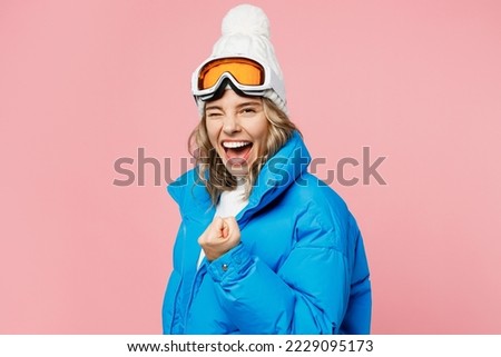 Side view snowboarder woman wear blue suit goggles mask hat ski padded jacket do winner gesture celebrate isolated on plain pastel pink background Winter extreme sport hobby weekend trip relax concept Royalty-Free Stock Photo #2229095173