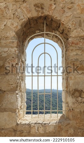 window of an old fortress with a lattice