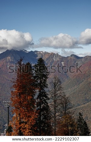 Mountains with snow-capped peaks. Beautiful panorama. Clouds over the mountains.