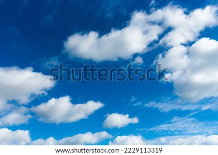 A stunning stark blue sky with white cumuli clouds.  Royalty-Free Stock Photo #2229113319