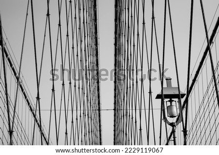 Abstract, minimalist view of Brooklyn Bridge cables and lantern, in black and white, nobody 