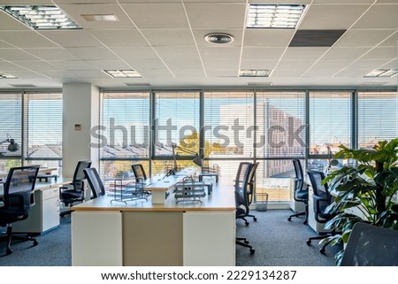 Empty places for workers in contemporary coworking. Startup business office interior at new workplace. Open space office interior Royalty-Free Stock Photo #2229134287