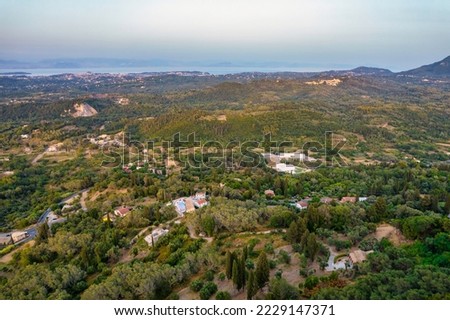 Aerial drone view over typical rural landscape in central Island of Corfu at sunset, Greece.