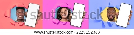 Great Offer. Excited young black people holding 3 big cell phones with white blank screen in hand, showing close up to camera through torn paper hole. Gadgets with empty free copy space, banner mockup