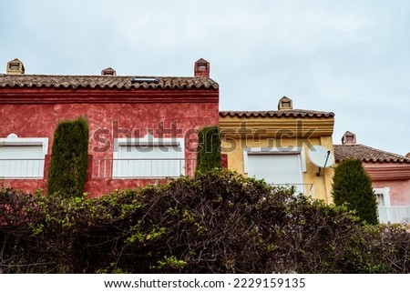 Colorful Spanish houses exterior photo surrounded with greenery