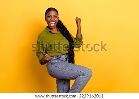 Portrait of attractive lucky cheerful wavy-haired girl great news rejoicing dancing isolated over bright yellow color background Royalty-Free Stock Photo #2229162011