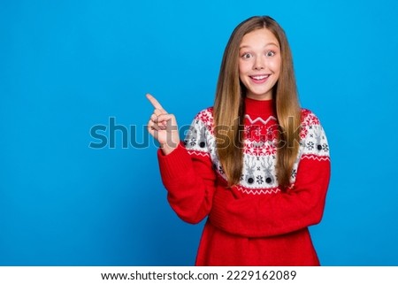 Photo of impressed ecstatic girl straight hairstyle dressed red pullover directing empty space discount isolated on blue color background