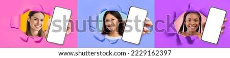 Mobile app. Three beautiful multiracial young women posing in torns in colorful paper walls, showing modern smartphones with white empty screens, mosaic of studio photos, mockup, collage, web-banner