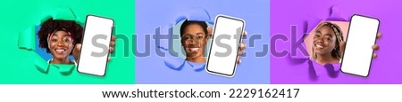 Three smiling stylish pretty young black ladies showing modern smartphones with white blank mockup screens through holes torns in colorful paper walls, recommending nice offer, collage, banner