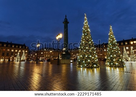 Vendome column with statue of Napoleon Bonaparte, on the Place Vendome decorated for Christmas at rainy night , Paris, France. Royalty-Free Stock Photo #2229171485