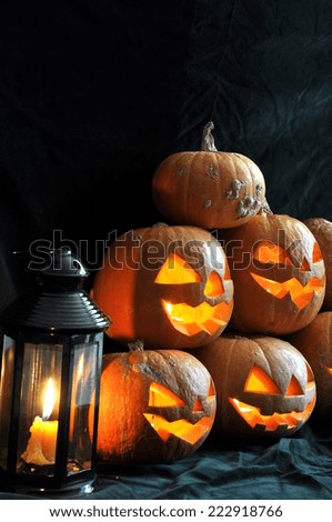 Halloween still life with pumpkins, candles and decorative lantern