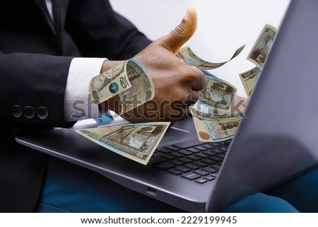 Guatemalan quetzal notes coming out of laptop with Business man giving thumbs up, Financial concept. Make money on the Internet, working with a laptop