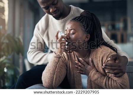 Deep breaths babe. Cropped shot of a handsome young man calming his girlfriend while she has an asthma attack at home. Royalty-Free Stock Photo #2229207905