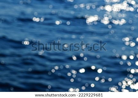 Abstract blur of bokeh waves on the sea