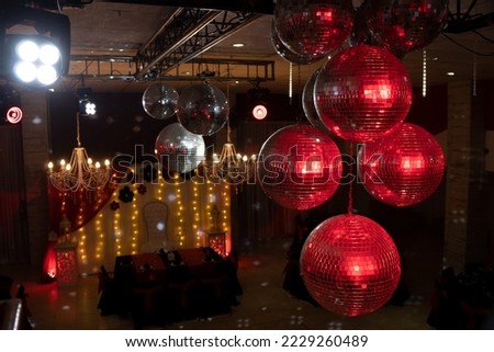 mirror balls with red light in party room