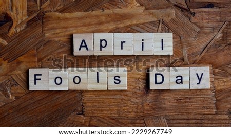 April Fools Day text on wooden square, holiday concept quotes