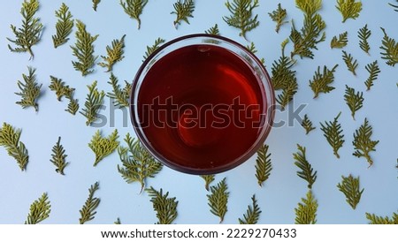A glass of tea on a blue background.