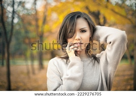 Autumn outdoor portrait of young beautiful mixed race woman 30 y. o.