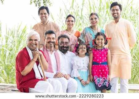 Group of rural people with senior man at village home. Royalty-Free Stock Photo #2229280223