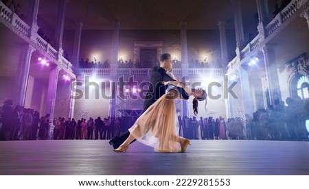Couple dancers perform waltz on large professional stage. Ballroom dancing. Royalty-Free Stock Photo #2229281553