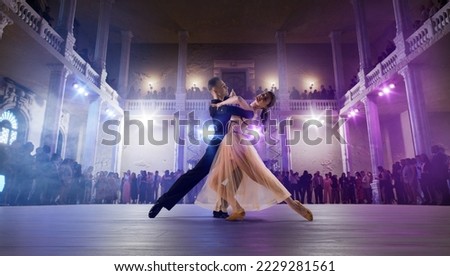 Couple dancers perform waltz on large professional stage. Ballroom dancing.