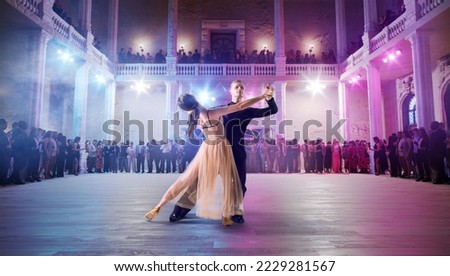 Couple dancers perform waltz on large professional stage. Ballroom dancing. Royalty-Free Stock Photo #2229281567