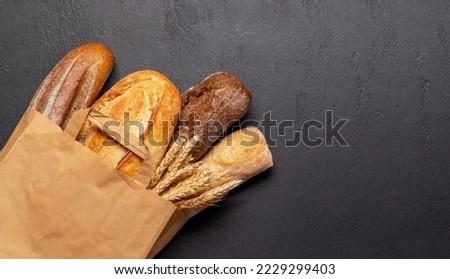 Fresh baked bread on stone table. Flat lay with copy space