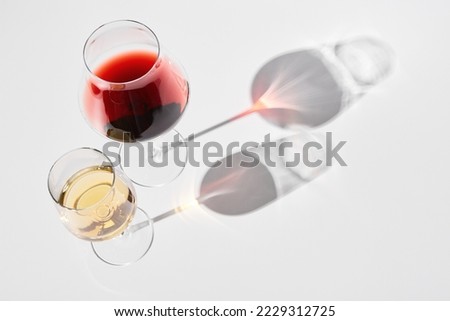 Wineglasses with red, white wine for gourmets.
