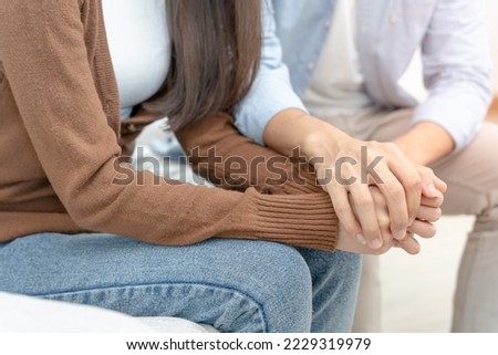 Couple hold hand support each while discussing family issues with psychiatrist. Husband encourages wife suffers depression. psychological, save divorce, Hand in hand together, trust, care, empathy Royalty-Free Stock Photo #2229319979