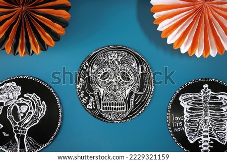 Halloween decorations on blue background, flat lay