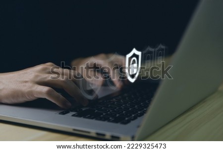 Businessman using laptop showing shield icon with lock sign. Computer password protection concept, internet network security, cyber digital technology, business information and virus protection.