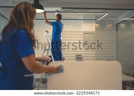 Cleaners do general cleaning of office premises Royalty-Free Stock Photo #2229348571