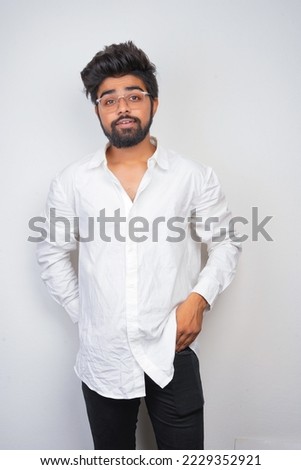 young indian man wearing white shirt and sunglasses. fashion concept. fade effect picture