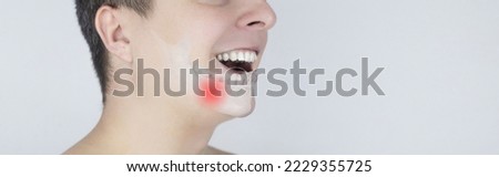 Schematic representation of pain in the jaw. Augmented reality. An x-ray of the jaw bone superimposed on a photograph. Painful areas are highlighted in red. Human bone disease. Osteomyelitis Royalty-Free Stock Photo #2229355725