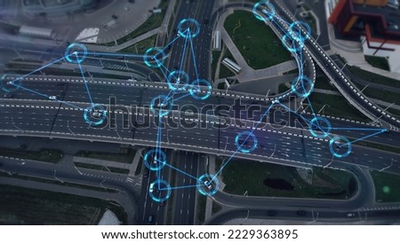 Concept of smart cars and transportation of the future. Automated robotic system remotely controls self-driving cars in the city. Artificial Intelligence Digitalizes and Analyzes Roads. Aerial view. Royalty-Free Stock Photo #2229363895