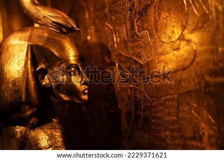 Egyptian Golden Goddess who shelters a box containing human organs, tomb of Pharaoh Tutankhamun. close up Royalty-Free Stock Photo #2229371621