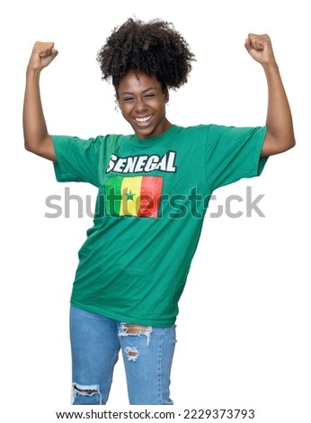 Cheering woman from Senegal supporting national football team isolated on white background for cut out Royalty-Free Stock Photo #2229373793