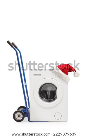 Santa claus hat on a washing machine isolated on white background
