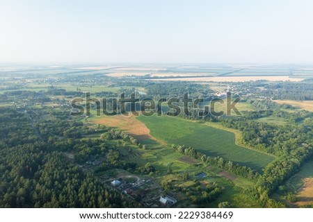 The countryside from the height is a green ecological area. Summer panorama of the countryside among the green trees - aerial drone shot.