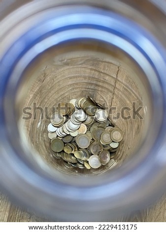 Coins saved in a water bottle. Photo taken from above. Turkish coin. Selective focus.
