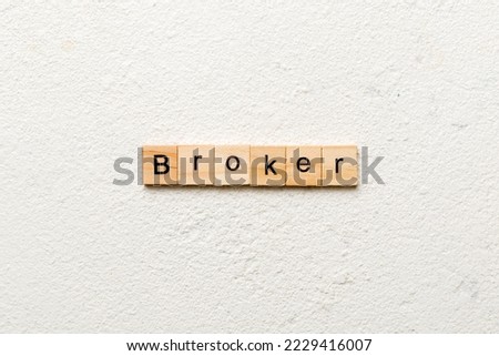 broker word written on wood block. broker text on cement table for your desing, concept.