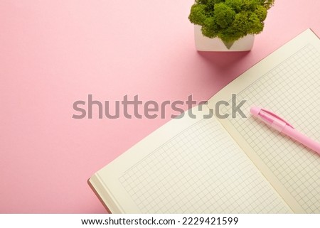 Open notebook and notebooks on pink background. Top view