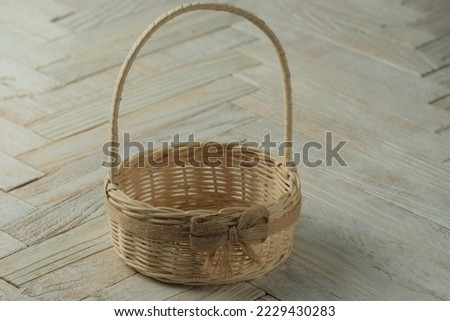 Bamboo basket on wooden background. Keranjang