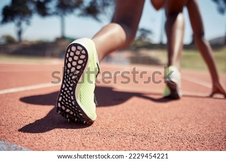 Runner, start race and closeup feet, legs or ready for competition, contest or sport event in sunshine. Athlete, training and running in position for fast speed on ground for success in summer run Royalty-Free Stock Photo #2229454221