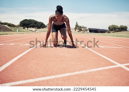 Fitness, running and woman at start line training for marathon race event at stadium. Exercise, sports and motivation for winning, black woman runner from Jamaica ready to run with focus and energy.