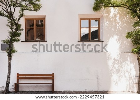 Old historic architecture in Italy. Traditional European old town building. Wooden windows, tree and colourful pastel walls with sunlight shadows. Aesthetic summer vacation travel background