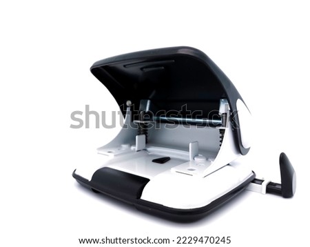 Black and white paper hole puncher, isolated on white background with copy space.