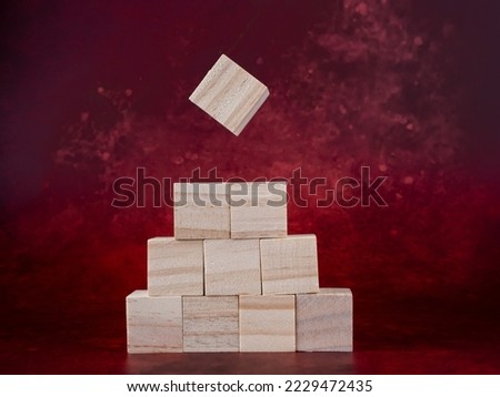 blank wooden blocks ready for graphics on a dark red background