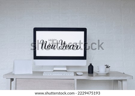 Mockup calendar with Happy New Year text on computer screen on the background